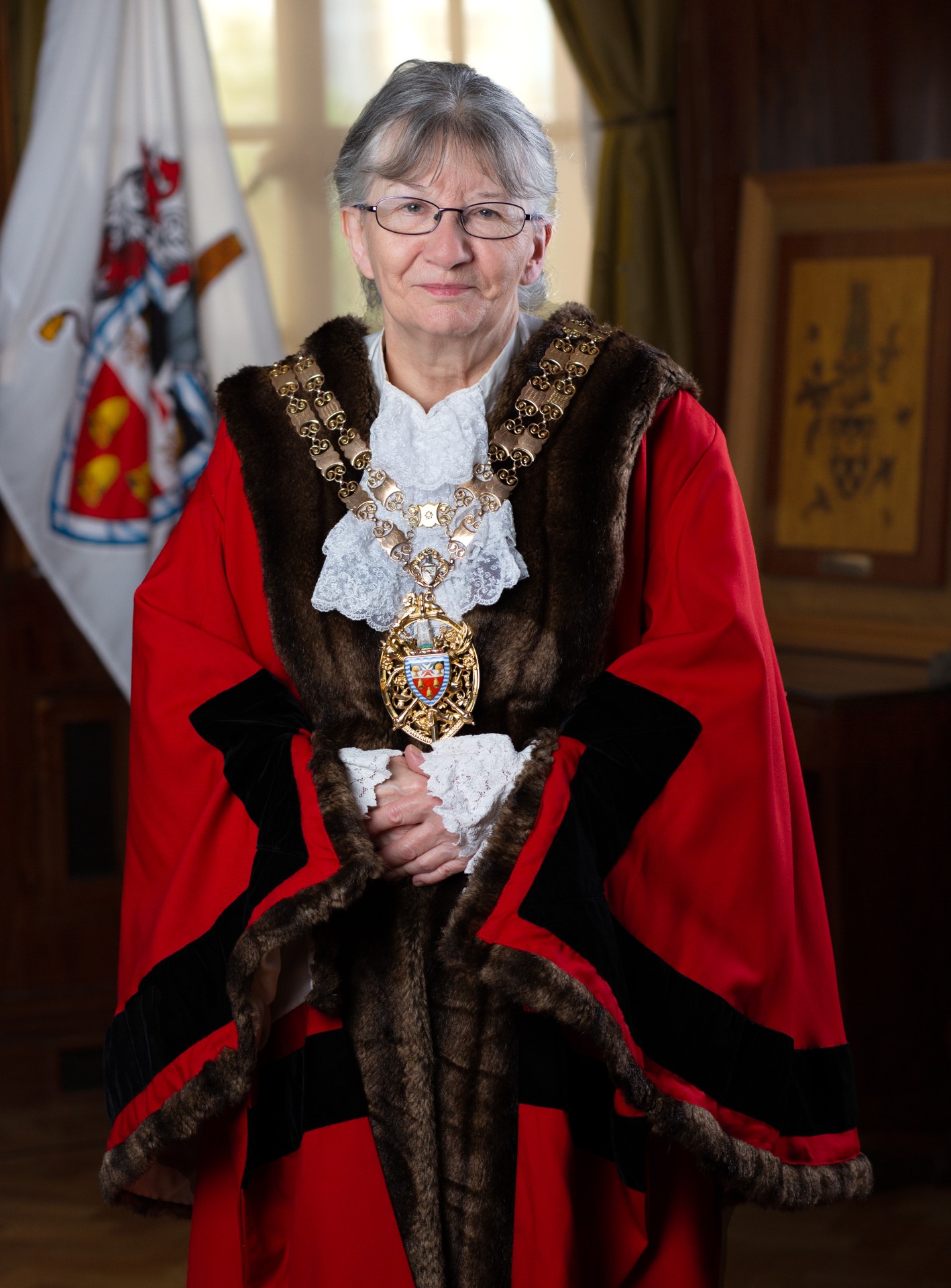 Professional portrait of the Speaker of Hackney wearing an official robe, smiling at the camera.